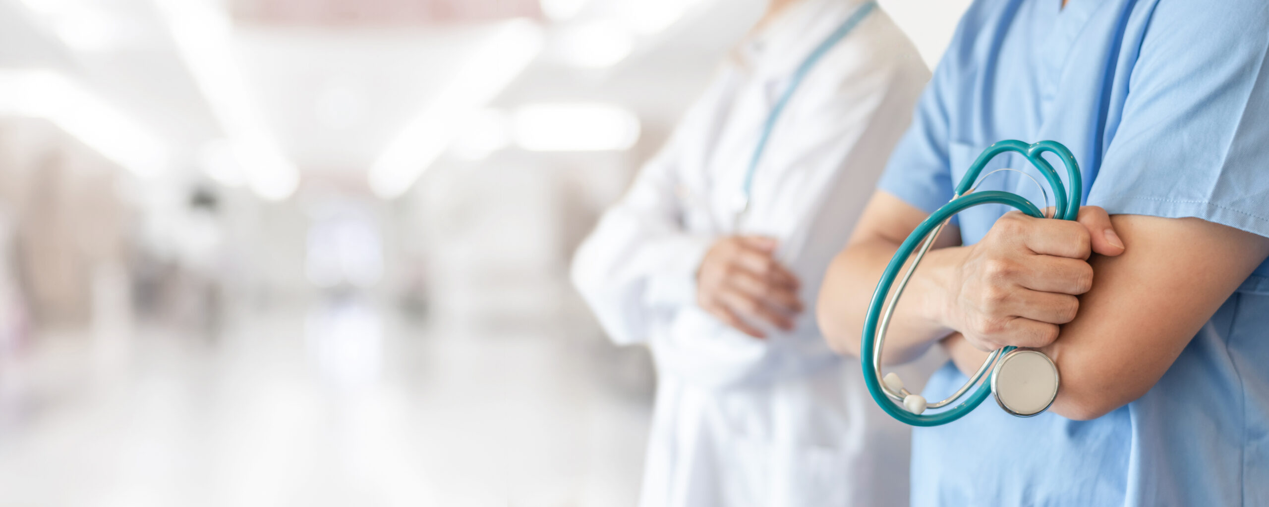 Get Medical Care - Doctors standing in hospital hallway