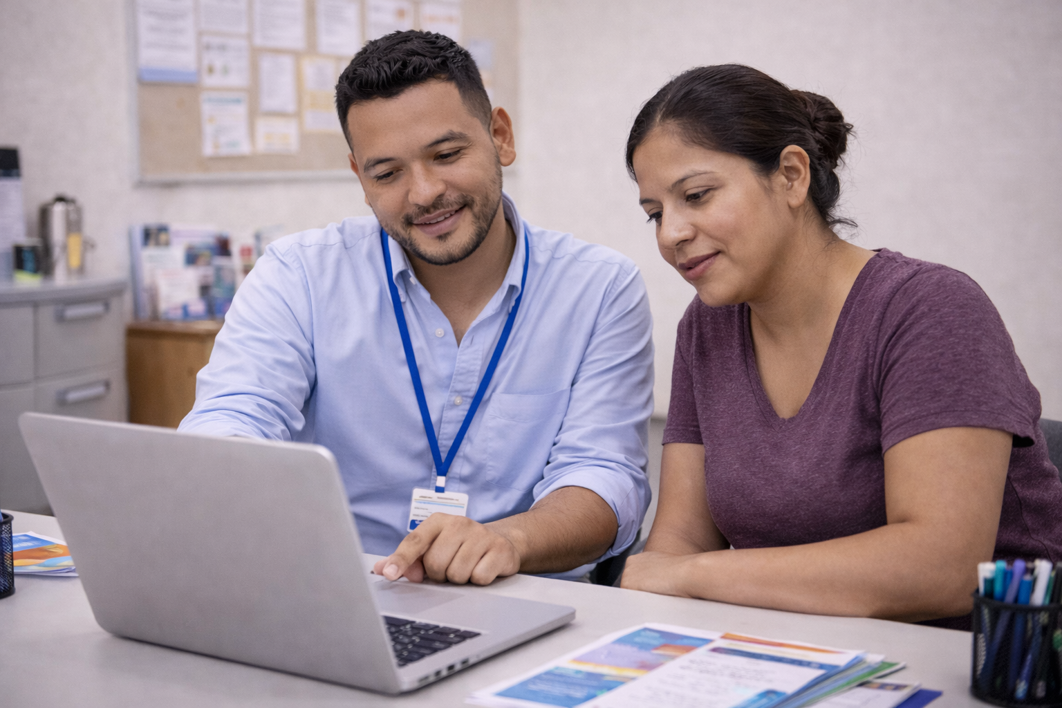 Case Worker assisting lady on computer